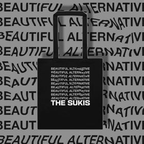 The Sukis Beautiful Alternative black tote bag on grey typographic background