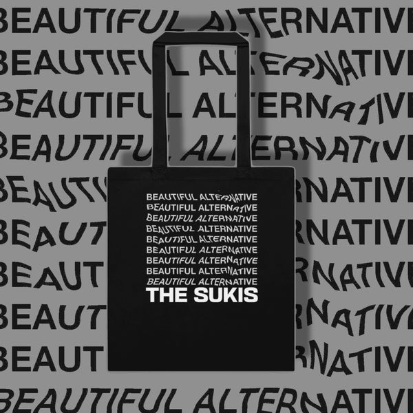 The Sukis Beautiful Alternative black tote bag on grey typographic background