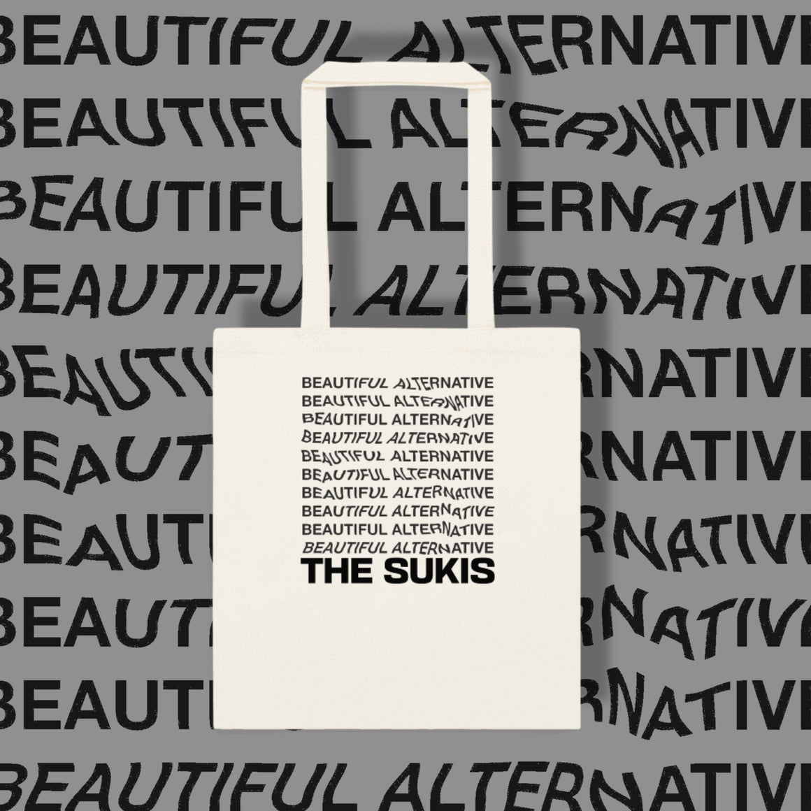 The Sukis Beautiful Alternative tote bag on grey typographic background